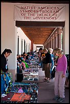 Tourists browse wares sold under native american vendors program of the palace of the governors. Santa Fe, New Mexico, USA (color)