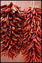 Strings of red peppers for sale. Santa Fe, New Mexico, USA (color)