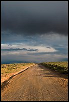 Dirt road under storm clouds. New Mexico, USA