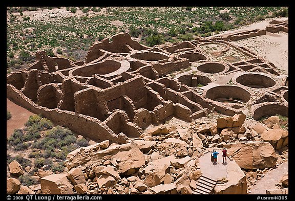 Tourists inspecting the complex room arrangement of Pueblo Bonito. Chaco Culture National Historic Park, New Mexico, USA (color)