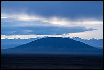 Ute Mountain with rain clouds at sunrise. Rio Grande Del Norte National Monument, New Mexico, USA ( color)