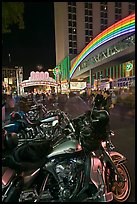 Harley-Davidson motorcycles on downtown street at night. Reno, Nevada, USA (color)