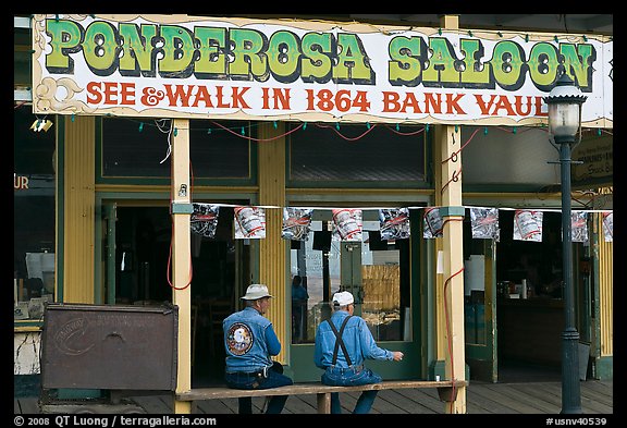 Men sitting on bench below Ponderosa Saloon sign. Virginia City, Nevada, USA