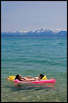 Girls laying on floating mattress, Sand Harbor, East Shore, Lake Tahoe, Nevada. USA