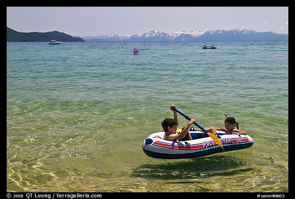 Children playing in inflatable boat, Sand Harbor, Lake Tahoe-Nevada State Park, Nevada. USA