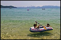 Children playing in inflatable boat, Sand Harbor, Lake Tahoe-Nevada State Park, Nevada. USA