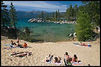 Young people sunbathing on sandy beach, Sand Harbor, Lake Tahoe, Nevada. USA