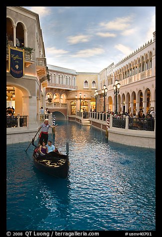 Gondolier singing song to couple during ride inside Venetian casino. Las Vegas, Nevada, USA (color)