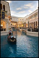 Gondolier singing song to couple during ride inside Venetian casino. Las Vegas, Nevada, USA (color)