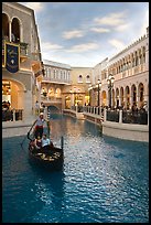 Gondolier singing song to couple during ride inside Venetian casino. Las Vegas, Nevada, USA