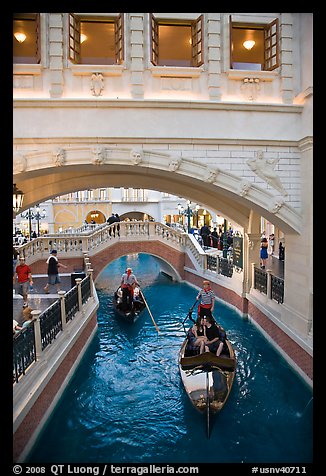 Couple kissing in gondola below bridge, Venetian casino. Las Vegas, Nevada, USA (color)