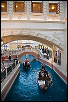 Couple kissing in gondola below bridge, Venetian casino. Las Vegas, Nevada, USA