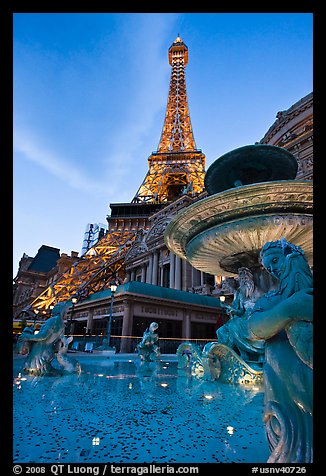 Fountain and Eiffel Tower replica at dusk, Paris casino. Las Vegas, Nevada, USA