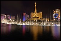 Bellagio dancing fountains and casinos reflected in lake. Las Vegas, Nevada, USA