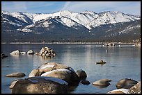 Boulders, kayak, and snowy mountains, Sand Harbor, Lake Tahoe-Nevada State Park, Nevada. USA ( color)