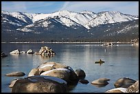 Boulders, kayak, and snowy mountains, Sand Harbor, Lake Tahoe-Nevada State Park, Nevada. USA