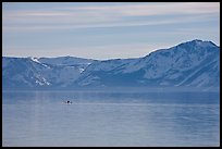 Kayak in the distance and mountains in winter, Lake Tahoe, Nevada. USA