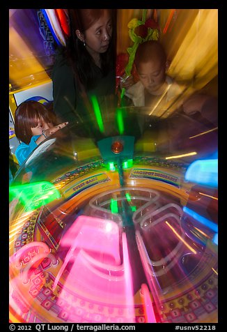 Arcade game light sweeps around players. Reno, Nevada, USA (color)