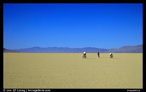 Three bicyclists on the desert Playa, Black Rock Desert. Nevada, USA