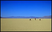 Three bicyclists on the desert Playa, Black Rock Desert. Nevada, USA