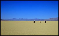 Three bicyclists on the desert Playa, Black Rock Desert. Nevada, USA ( color)