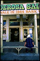 Man with cowboy hat sitting in front of a casino. Virginia City, Nevada, USA (color)