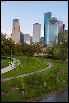 People walking in park with skyline behind. Houston, Texas, USA ( color)