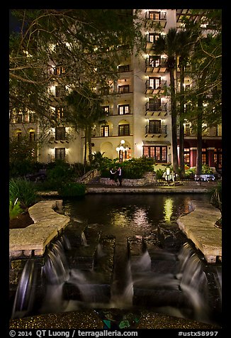 Waterfall, elegant couple in distance. San Antonio, Texas, USA (color)