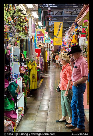 Man with cowboy hat and woman look at crafts, Market Square. San Antonio, Texas, USA (color)