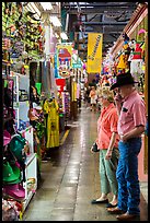 Man with cowboy hat and woman look at crafts, Market Square. San Antonio, Texas, USA ( color)