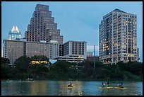 Water pedaling in front of skyline at dusk. Austin, Texas, USA ( color)