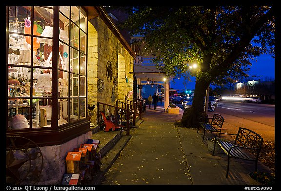 Sidewalk and stores at dusk. Fredericksburg, Texas, USA (color)