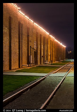 Railroad tracks and brick buildings at night, Stockyards. Fort Worth, Texas, USA (color)