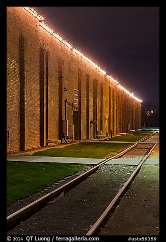 Railroad tracks and brick buildings at night, Stockyards. Fort Worth, Texas, USA (color)
