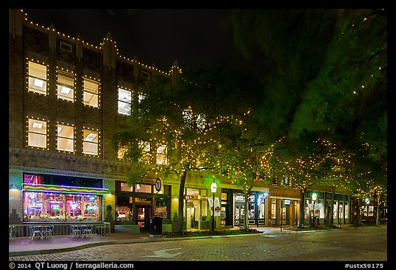 Street at night with lighted stores. Fort Worth, Texas, USA (color)