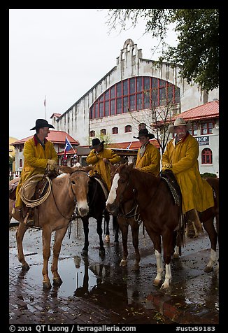 Cowboys in raincoats in front of Cowtown coliseum. Fort Worth, Texas, USA (color)