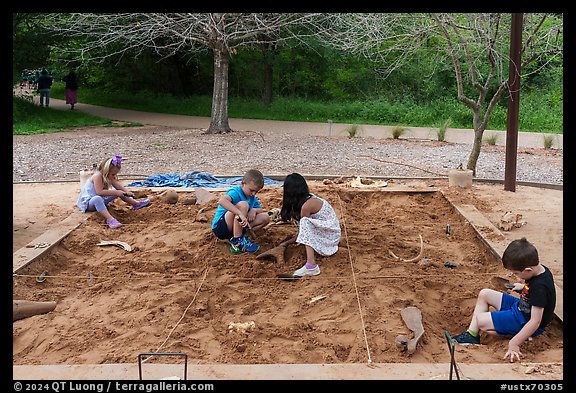 Children play in dig playground. Waco Mammoth National Monument, Texas, USA (color)