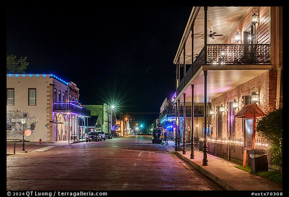 Street with historic buildings at night. Jefferson, Texas, USA (color)