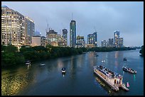 Skyline and tour boats on Colorado River at dusk. Austin, Texas, USA ( color)