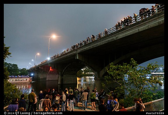 People gathered on Congress Bridge to watch bat fly. Austin, Texas, USA (color)