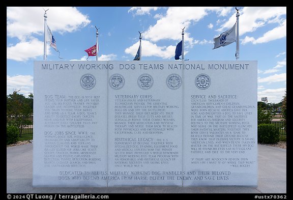 Granite wall with history incriptions, and the five US Armed Service flags, Military Working Dog Teams National Monument. San Antonio, Texas, USA (color)