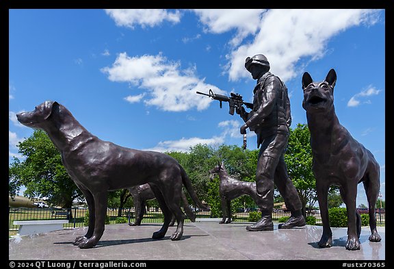 Sculpture of dog handler holding leash and M4 rifle with dogs, Military Working Dog Teams National Monument. San Antonio, Texas, USA (color)