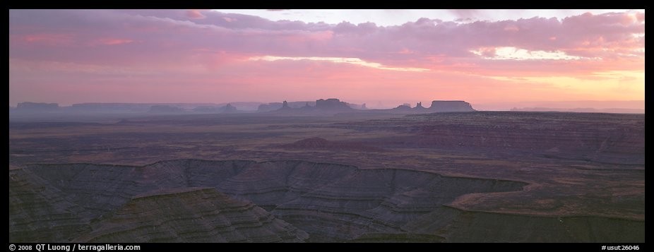 Sunset over canyon and distant mesas. Monument Valley Tribal Park, Navajo Nation, Arizona and Utah, USA
