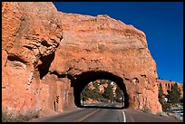 Road tunnel in pink limestone cliff. Utah, USA