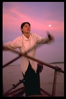 Sunset on the Mekong river with a traditional paddler, Can Tho