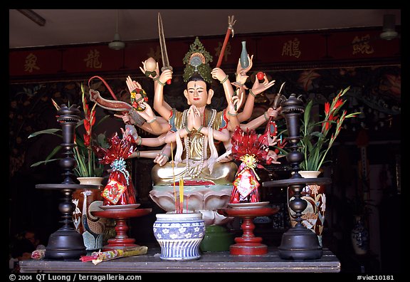 Altar with a multiple-armed buddhist statue. Ho Chi Minh City, Vietnam (color)