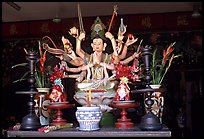 Altar with a multiple-armed buddhist statue. Ho Chi Minh City, Vietnam