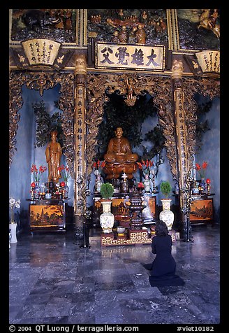 Woman praying at the altar. Ho Chi Minh City, Vietnam (color)