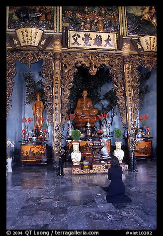 Woman praying at the altar. Ho Chi Minh City, Vietnam