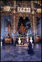 Woman praying at the altar. Ho Chi Minh City, Vietnam (color)